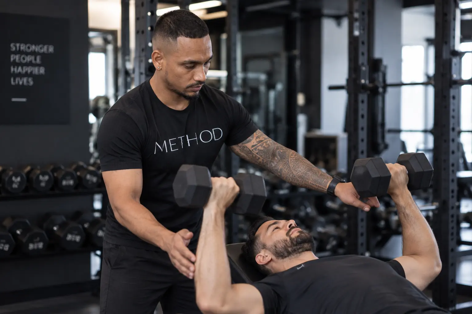 Deep coaching a client through a dumbbell press